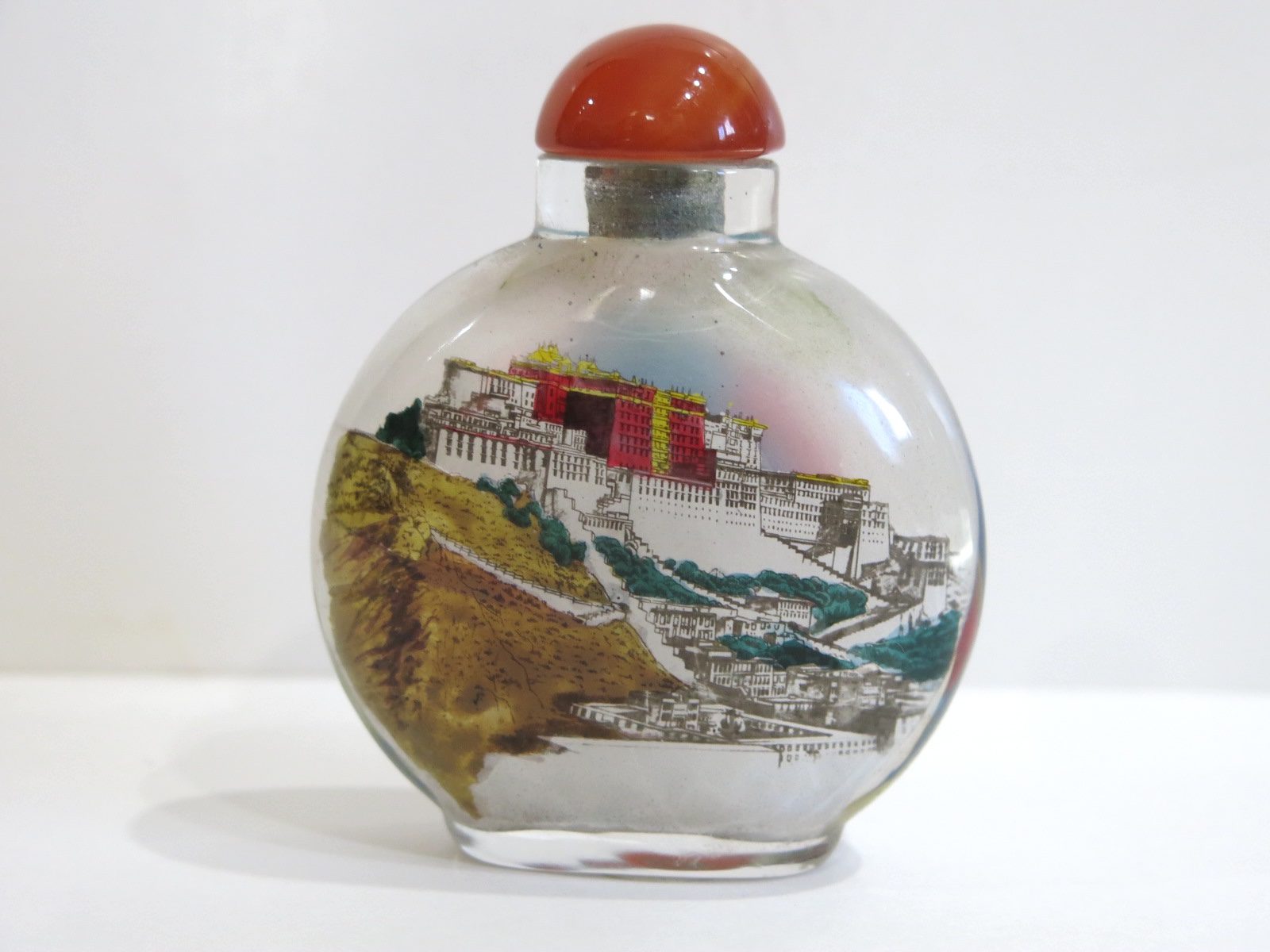 Chinese Reverse Painted Snuff Bottle with Lhasa Temple and Buddha